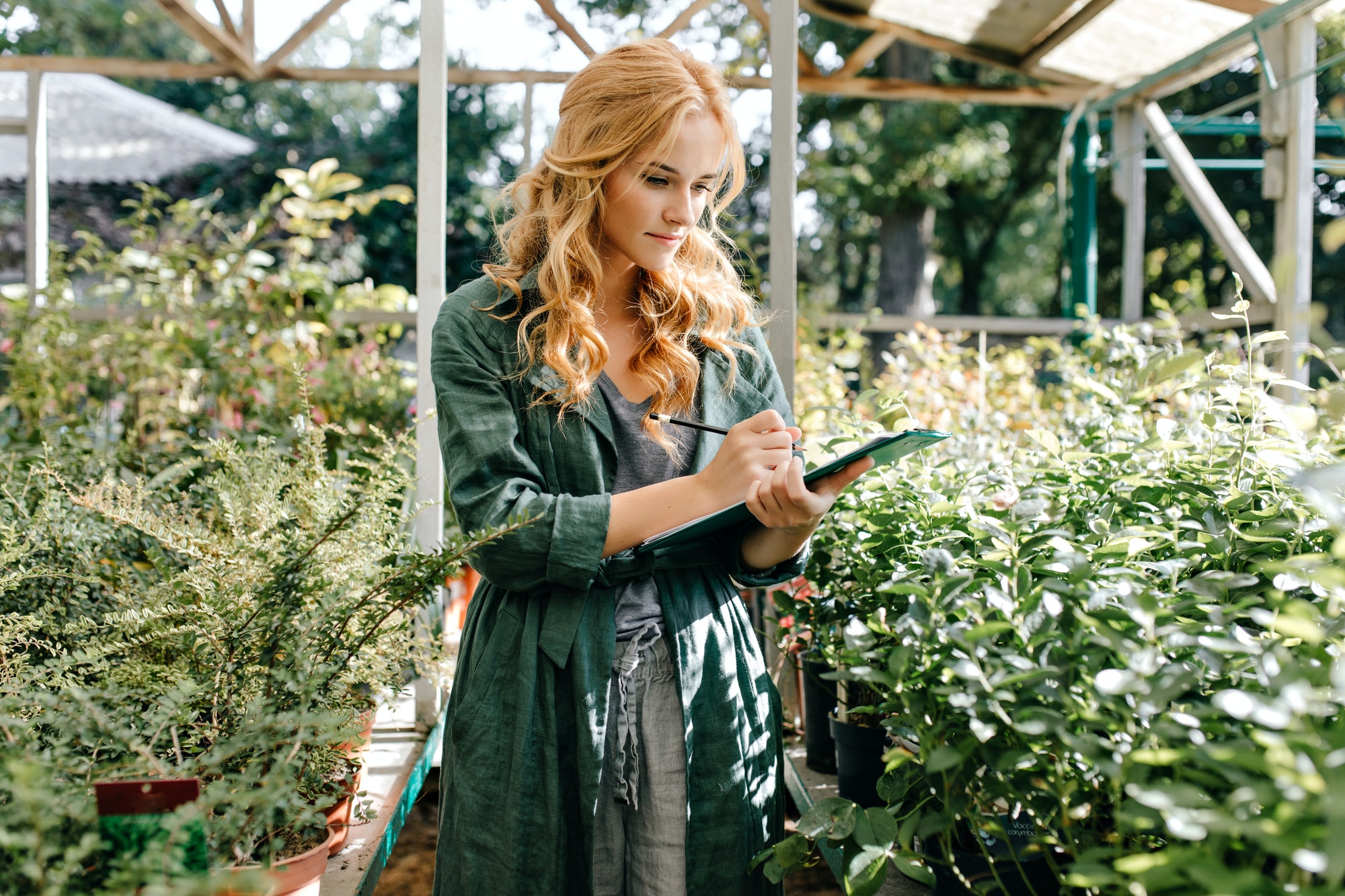 a local florist checks clipboard at flower shop in clayton nc