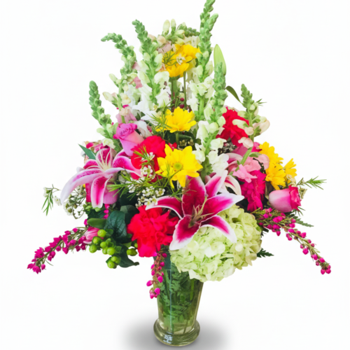 The Timeless Garden Bloom Vase from The Florist at Plantation features pink lilies, yellow daisies, white snapdragons, and lush greenery—perfect for Clayton NC flower delivery.