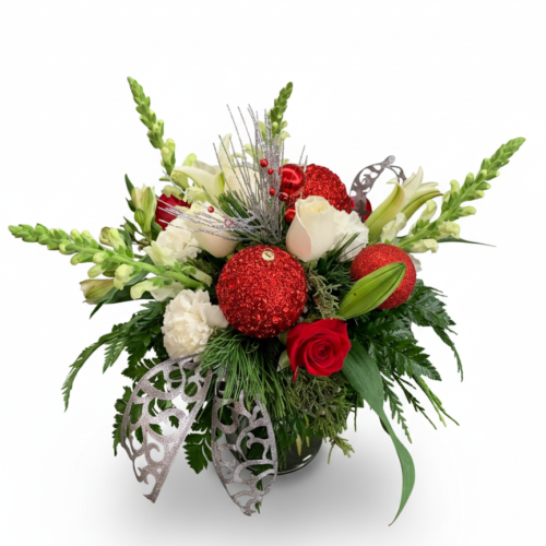 Holiday Sparkle features red roses, white lilies, snapdragons, and carnations with sparkling red ornaments and silver leaves. Expertly designed by Clayton Florist—your trusted Clayton NC florist.
