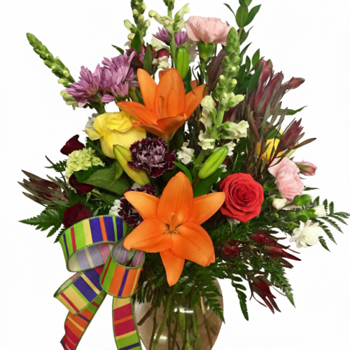 Lilies on Parade—a glass vase brimming with orange lilies, red and yellow roses, and more, topped with a striped ribbon. Perfect for any occasion. Order now with Clayton NC Flower Delivery from your local Clayton florist.