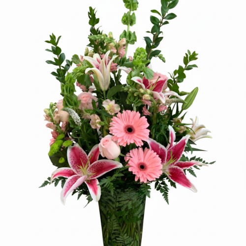 The Blush & Stargazer Elegance Vase features pink lilies, gerbera daisies, roses, snapdragons, and lush greenery—artfully arranged by your Local Florist in Clayton and perfect for Clayton NC Flower Delivery.