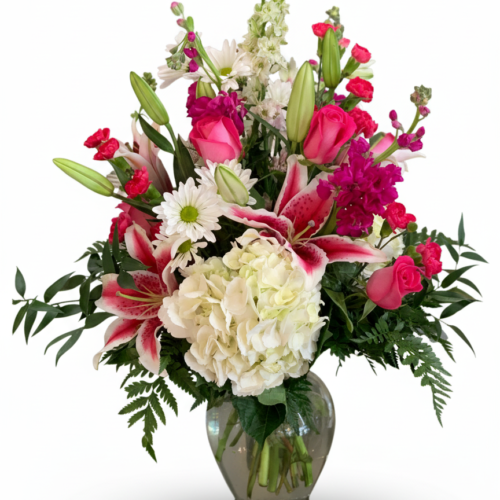 The My Heart is Yours Bouquet features pink roses, white lilies, daisies, carnations, hydrangeas, and greenery in a glass vase—an elegant arrangement from The Florist at Plantation, your trusted Clayton florist.