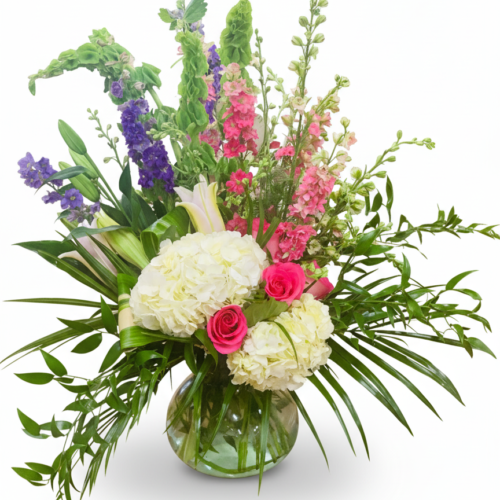 Pastel Elegance: A glass vase filled with pink roses, hydrangeas, snapdragons, lilies, and lush foliage—beautifully arranged by The Florist at Plantation, your trusted Clayton NC florist.