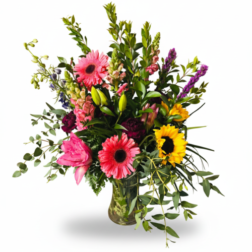 Rustic Sunshine: A glass vase with sunflowers, pink gerbera daisies, lilies, and fresh greenery—arranged beautifully by your trusted Clayton NC Florist. Perfect for flower delivery in Clayton NC.