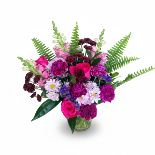 Radiant Berry Garden features pink, purple, and magenta roses, carnations, and daisies with green ferns in a clear glass vase—expertly arranged by your local florist in Clayton.