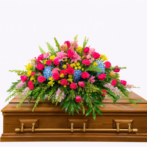 The Florist at Plantation offers the Colorful Gathering Casket Spray—a wooden casket adorned with pink roses, blue hydrangeas, yellow blooms, and greenery. Trust us for beautiful flower delivery in Clayton NC.