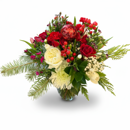 The Holiday Wishes Bouquet features red and white roses, chrysanthemums, red berries, greenery, and a red “I love you” balloon in a clear vase. Available from Clayton Florist—your trusted Clayton NC florist for any occasion.