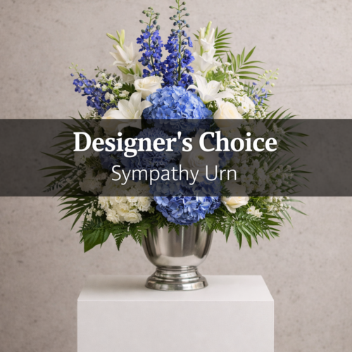 A silver urn with blue, white, and green blooms sits on a pedestal against a light grey background. Text reads Sympathy Urn - Designers Choice. Order from your local florist in Clayton for thoughtful Clayton NC flower delivery.