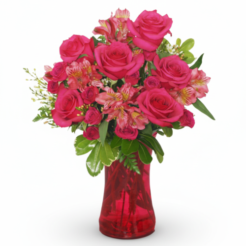 Richly Romantic features vibrant pink roses and alstroemeria with lush greenery, artfully arranged in a glossy red glass vase by The Florist at Plantation—set against a plain white background.