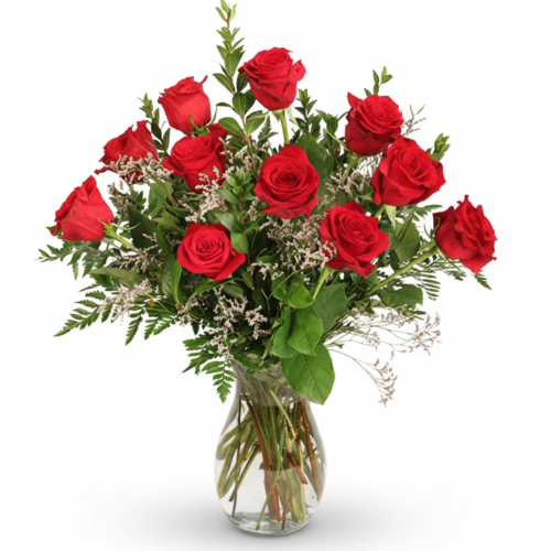 The Classic Dozen Roses features a clear glass vase with twelve red roses, green fern leaves, and white filler flowers—beautifully arranged by your Clayton florist against a white background.