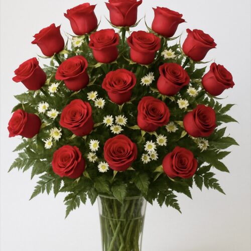 A glass vase of 24 red roses arranged in a fan shape with white daisies and ferns, set against a white background—ideal for Clayton NC Flower Delivery.