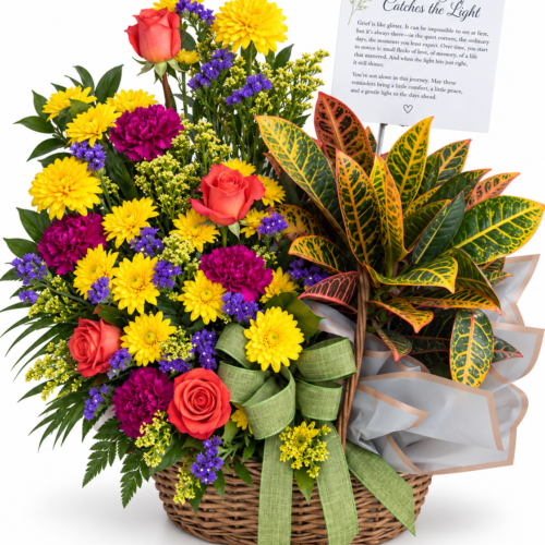 Fresh flowers with a green plant in a basket with a green ribbon And grief poem by Clayton Florist